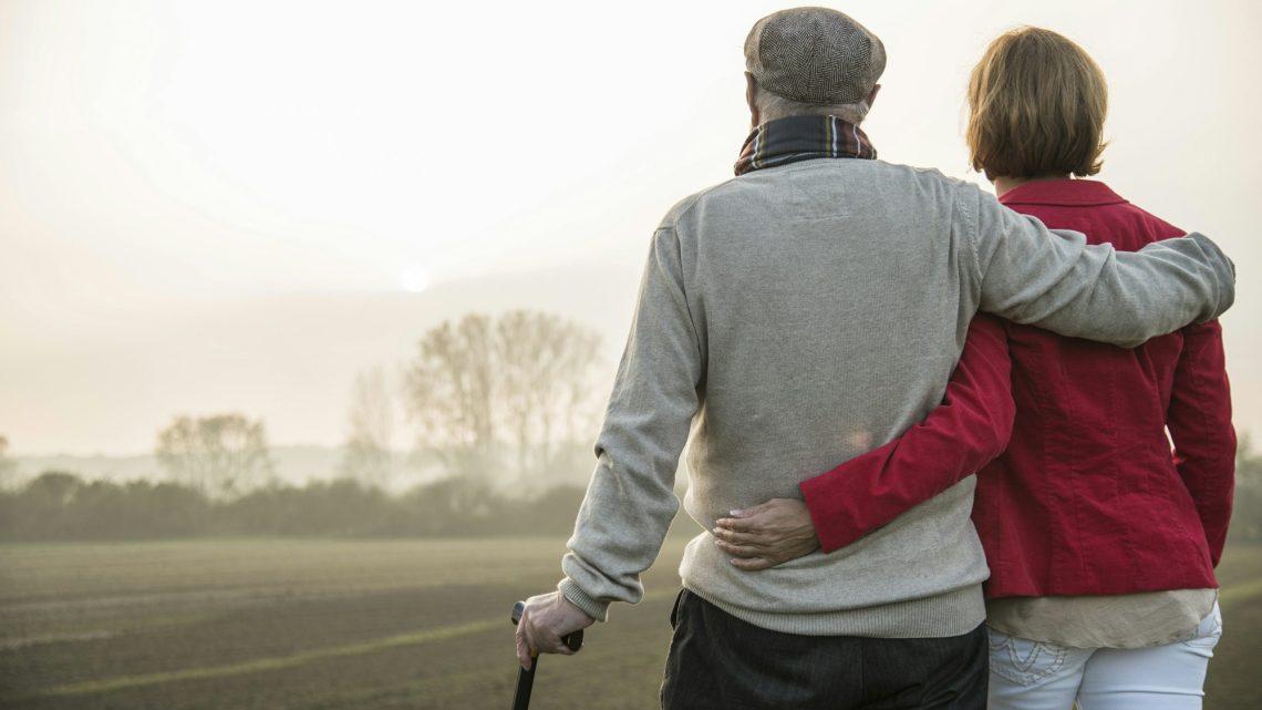 Senior man and daughter in rural landscape